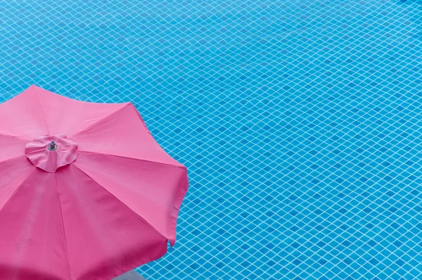 Red umbrella on swimming pool in summer — Stock Photo, Image