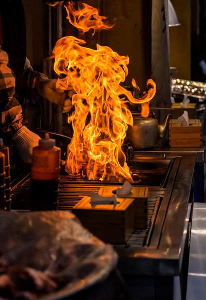 Chef grilling bbq with flame of burning in restaurant — Stock Photo, Image