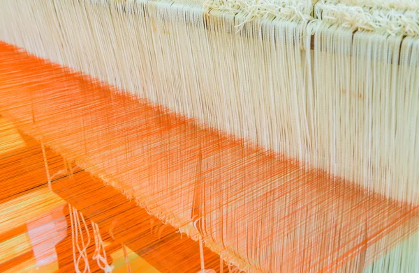 Weaving loom and shuttle on the warp — Stock Photo, Image