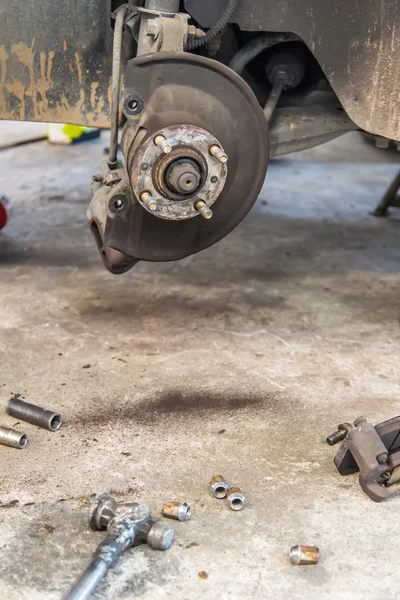 Car under repair on hoist at service station — Stock Photo, Image