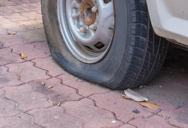 Deflated damaged tyre on car wheel — Stock Photo, Image