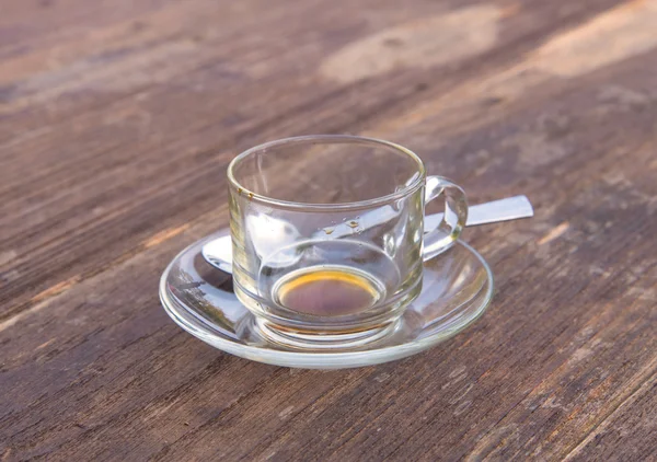 Empty glass after drink coffee on wood table — Stock Photo, Image