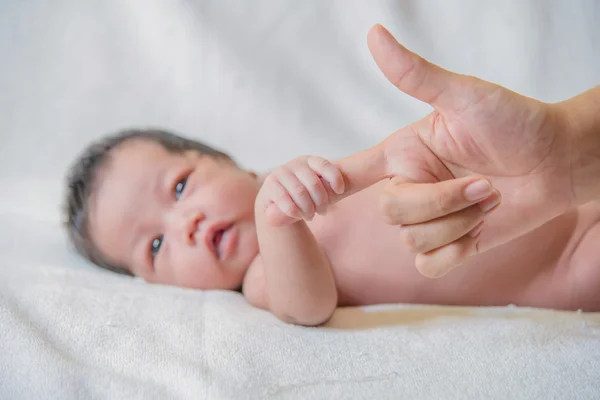 Cute newborn baby hand holding mother's finger — Stock Photo, Image