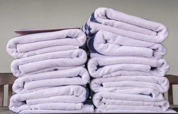 Stack of bath towels on wooden table — Stock Photo, Image