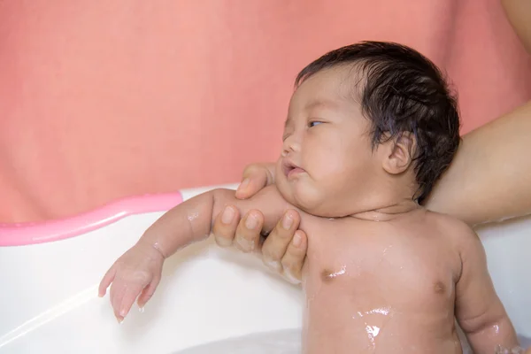 Newborn baby taking a bath by mother at home, asian child — Stock Photo, Image