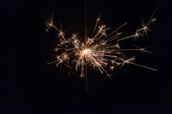Hand holding a sparkler fire on black background — Stock Photo, Image