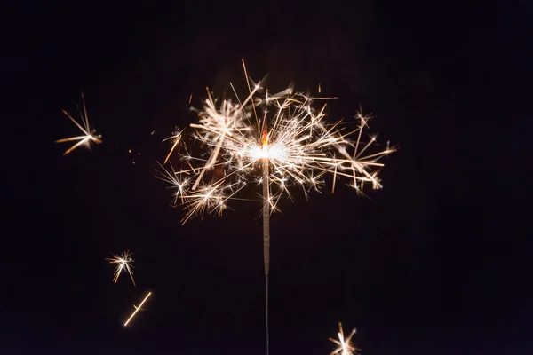 Hand holding a sparkler fire on black background — Stock Photo, Image