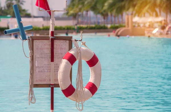 Red lifebuoy near public swimming pool — Stock Photo, Image