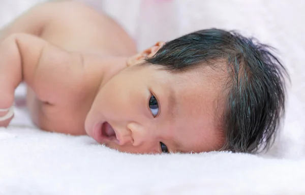 Portrait of cute newborn baby girl on the bed — Stock Photo, Image