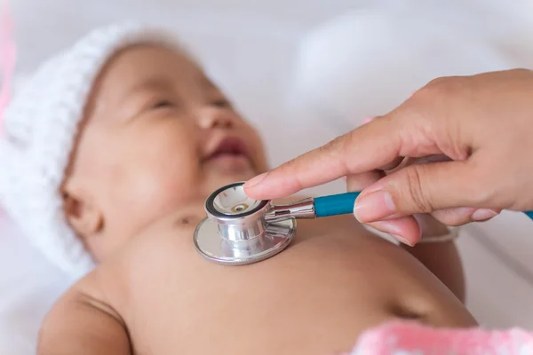 Pediatric doctor exams newborn baby girl with stethoscope in hos — Stock Photo, Image