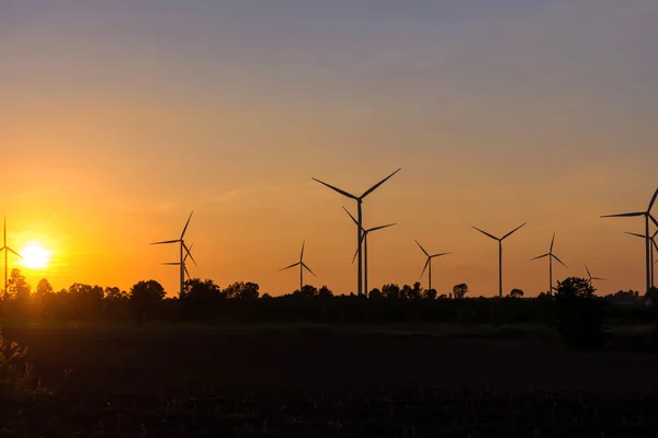 Eco power in wind turbine farm with sunset — Stock Photo, Image