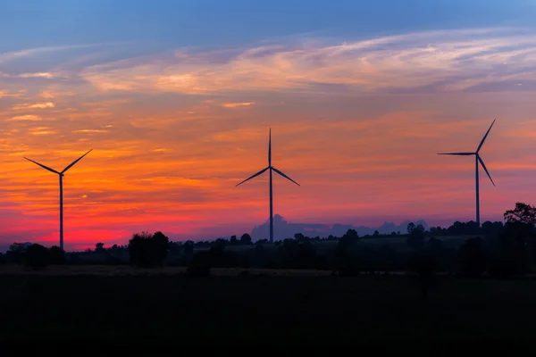 Eco power in wind turbine farm with sunset — Stock Photo, Image