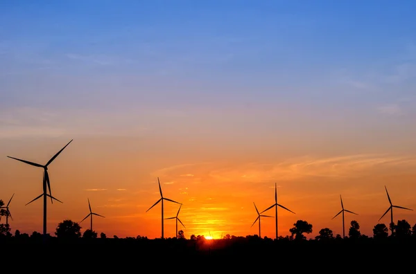 Eco power in wind turbine farm with sunset — Stock Photo, Image