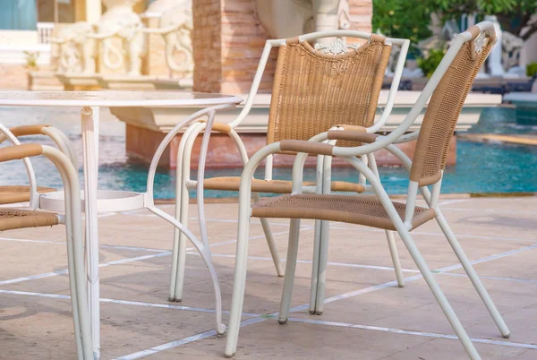 Chairs and tables next to swimming pool — Stock Photo, Image