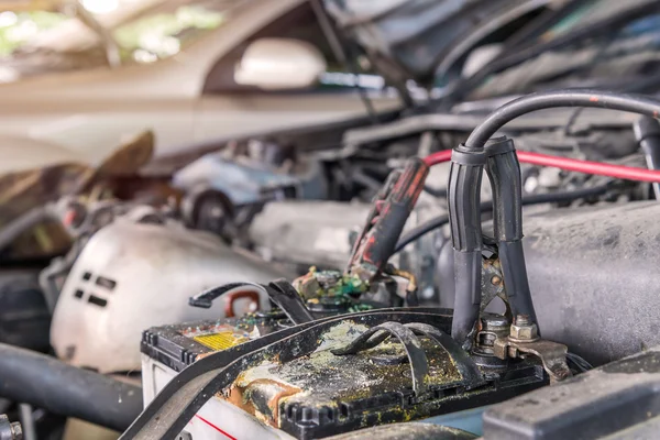 Charging car with electricity trough cables in auto repair shop — Stock Photo, Image