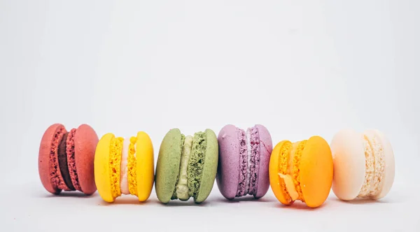 stock image Pastel colored macarons sweet French dessert isolated on white background.