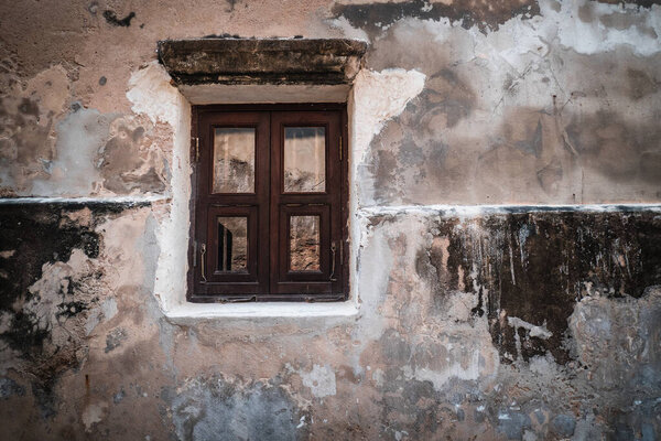 Antique old window on loft industrial grunge exterior wall. Old brick walls and window.