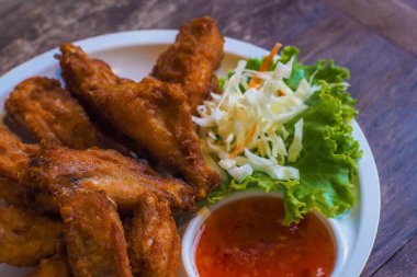 fried chicken wings with vegetable on white plate delicious food still life.