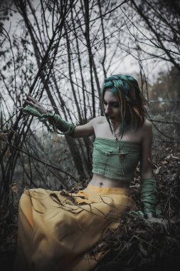 Sonbahar yeşili içinde yeşil ve sarı cüppeli ölü bir kız.