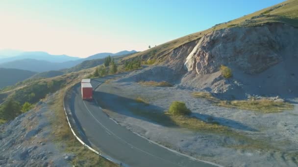 Drone follows Logistic Trailer Trucks driving on mountain road — Stock Video