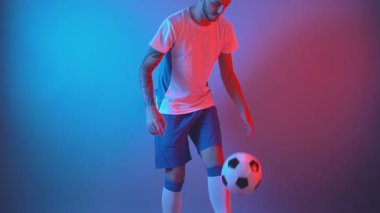 Profesyonel futbolcu bacaklarıyla hokkabazlık yaparak ısınıyor. Yavaş çekim, ön görünüm