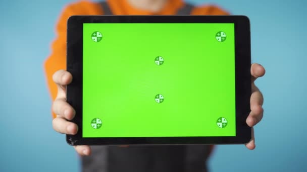 Невідомий ремонтник тримає планшет з зеленим екраном проти камери — стокове відео