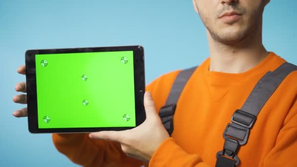 Giovane in abiti da lavoro in possesso di un tablet con schermo verde e sorridente — Video Stock