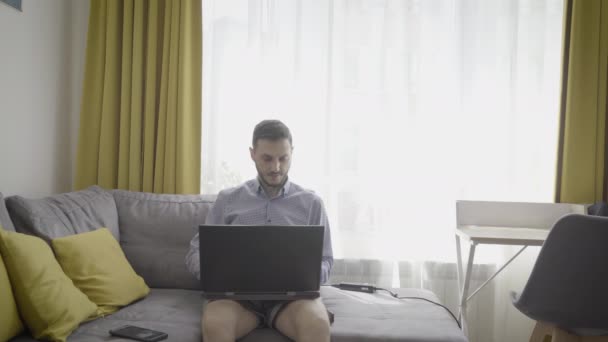 Millennial homem trabalhando no laptop em casa negociação criptomoeda — Vídeo de Stock