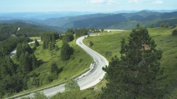 Vista aérea del sedán plateado que conduce a través del camino de montaña del bosque — Vídeos de Stock
