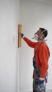 Skilled Worker Applying Wall Plaster with Roller and Knife Finishing Process in Modern Interior Vertical. High quality 4k footage