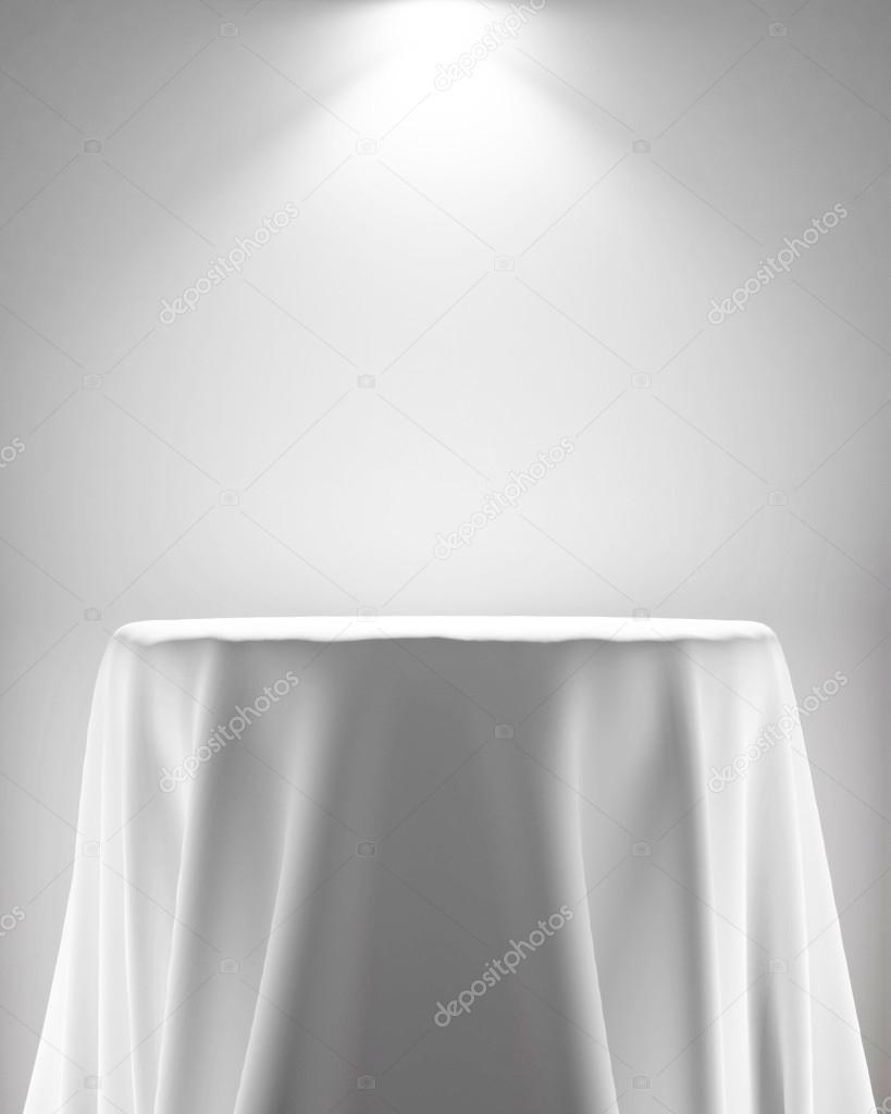 Presentation pedestal covered with white silk cloth