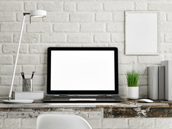 Laptop on wooden table, white brick wall