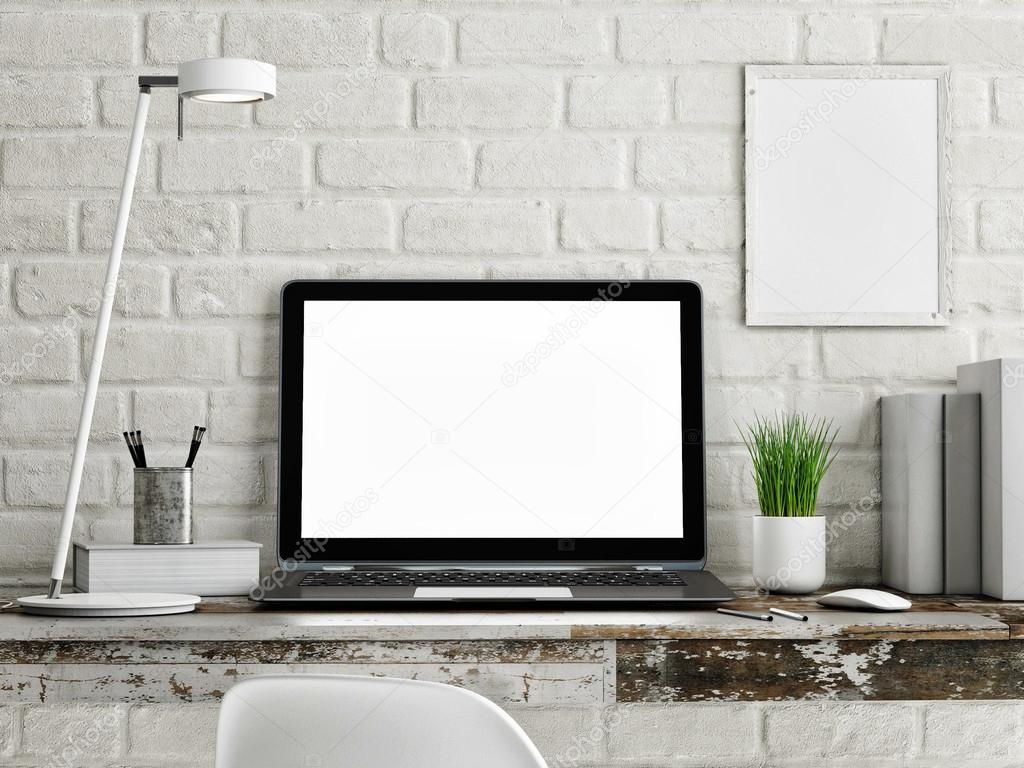 Laptop on wooden table, white brick wall