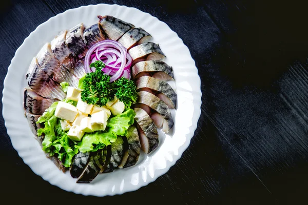 Chopped roasted and pickled herring with onions cheese and herbs — Stock Photo, Image