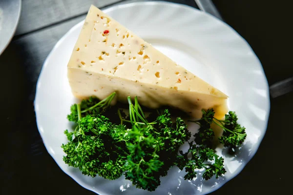 Cheese with spices, a triangle of cheese and parsley — Stock Photo, Image