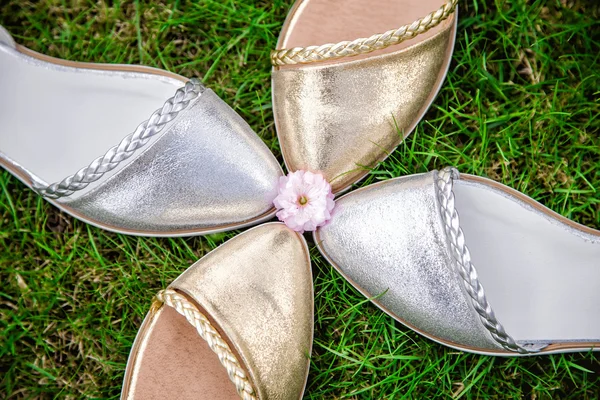 Silver and gold sandals in the shape of a flower — Stock Photo, Image