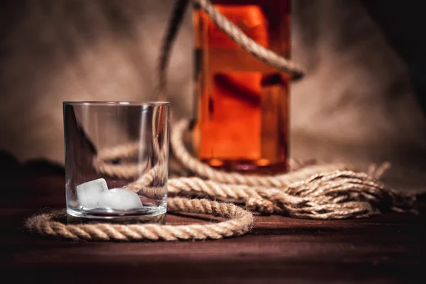 Bourbon whiskey rum in a glass with ice — Stock Photo, Image