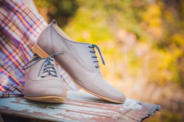 Chaussures en cuir pour femmes avec lacets sont sur une nappe à carreaux — Photo