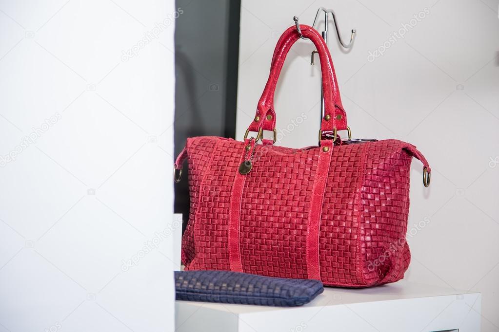 Red female bag on a shelf in the store