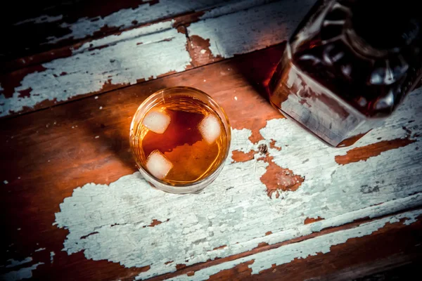 Two glasses of whiskey vintage photo, a bottle on the bar — Stock Photo, Image