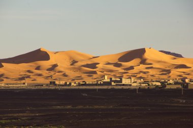 The Dunes Of Erg Chebbi Above The Merzouga Village In Morocco clipart