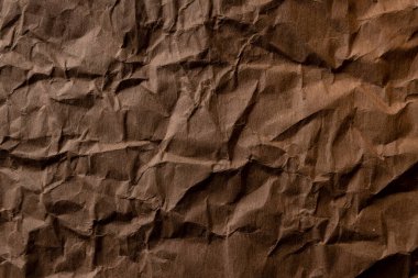 Buruşmuş kağıt. Kahverengi karton kağıt. yüksek çözünürlüklü detaylı doku. Duvar kağıdı için soyut arkaplan.