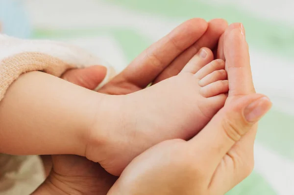 大人の手に新生児の小さな足 — ストック写真