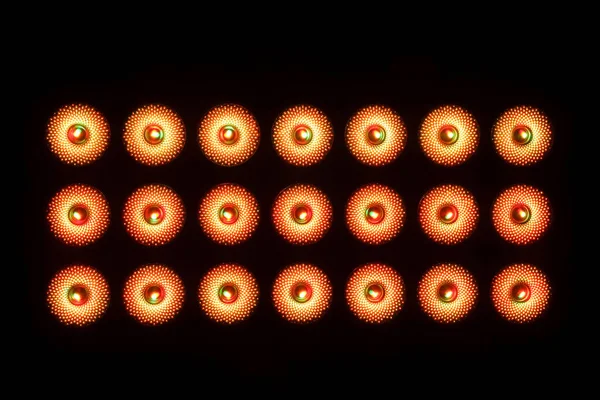 Three rows of LED illuminators on a black background. Frontal view. Close-up.