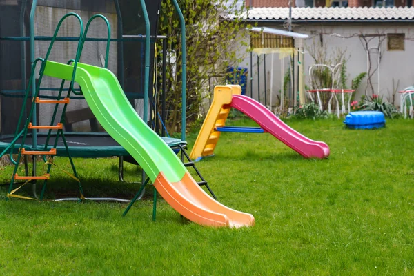 Two Plastic Multi Colored Slides Playground Green Grass Lawn — Stock Photo, Image
