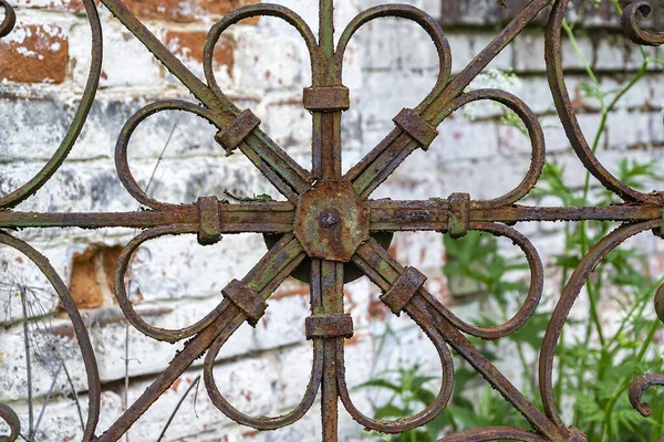 antique, rusty, shaped metal grating, welded from thick wire
