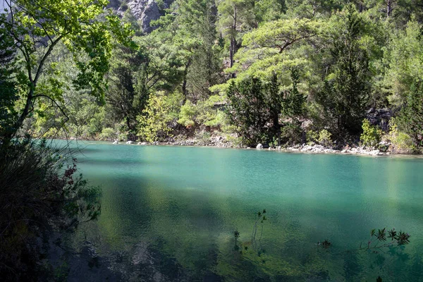 Lago com água azul e verde é cercado por rochas no cânion Goynuk, distrito de Kemer, na província de Antalya, Turquia. — Fotografia de Stock