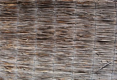 Wicker fence background. Wicker texture. Old decorative surface. Wooden fence.