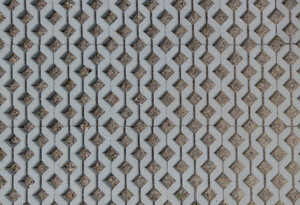 Geometric Concrete Of Parking Whith Green Grass. Grey Concrete Tile With Cells Of Eco Parking With Hole For Grass, Top View.