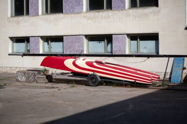 Otoparkta karavanda eski bir katamaran teknesi. Ölü tekne hurdalığı.
